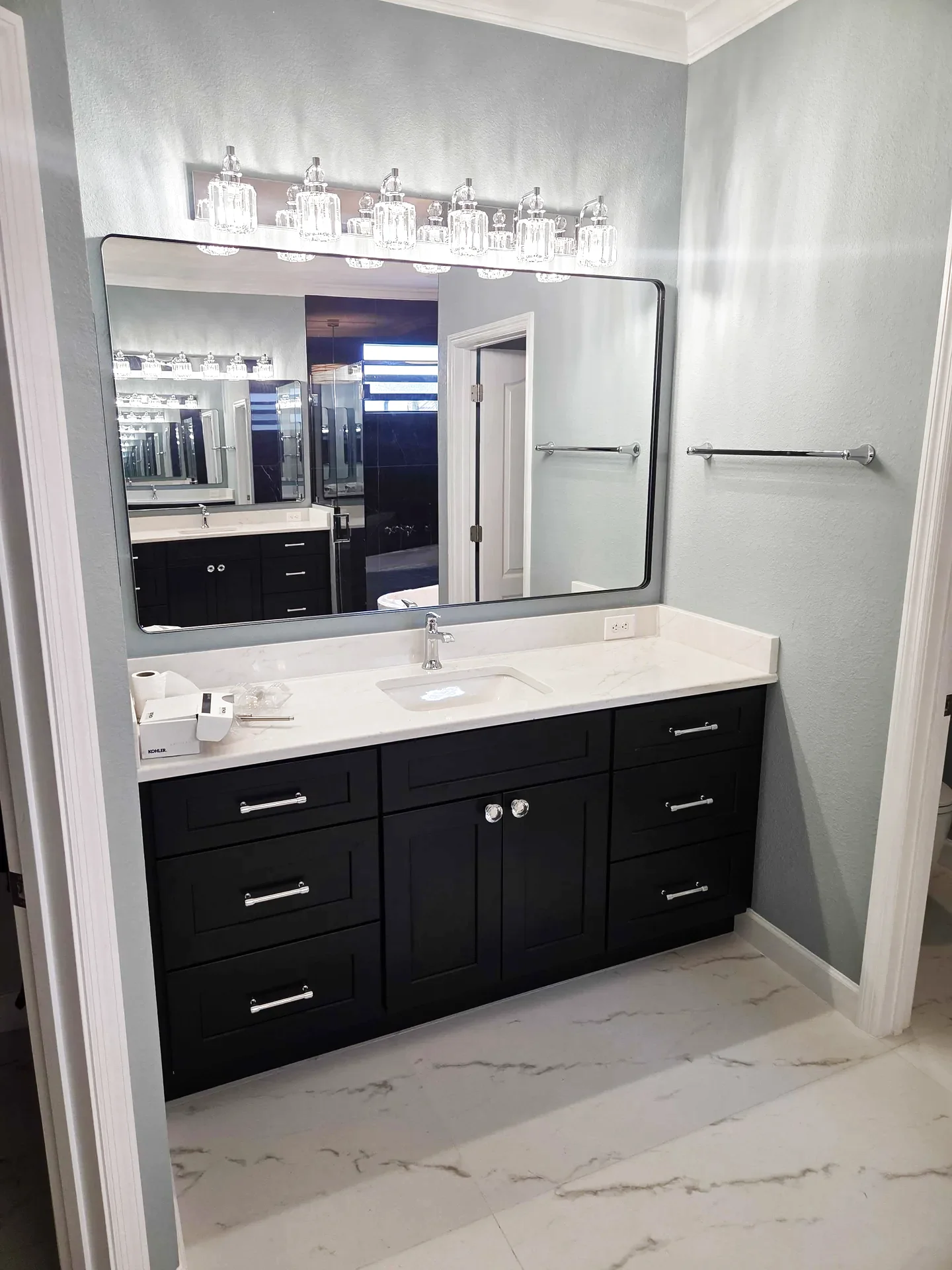 Black shaker vanity with crystal lighting